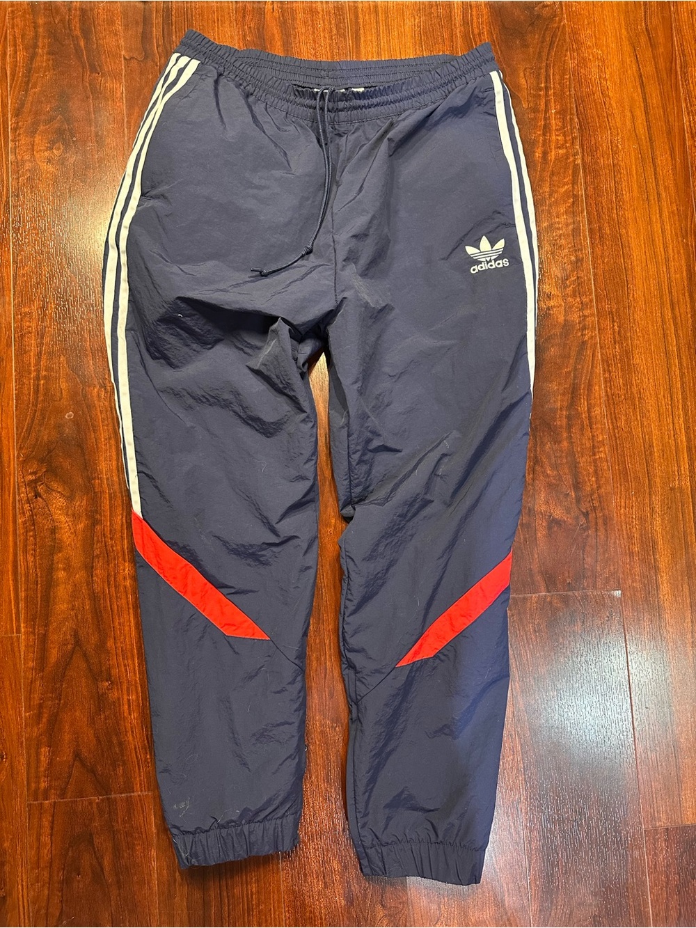 adidas Navy Track Pants with White Stripes and Red Knee Panels